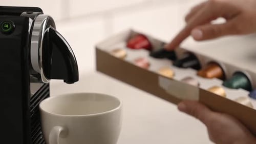 Hand Selects Coffee Pod For Espresso Machine