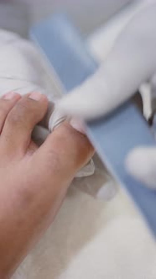 Toe getting a Pedicure in Nail Salon