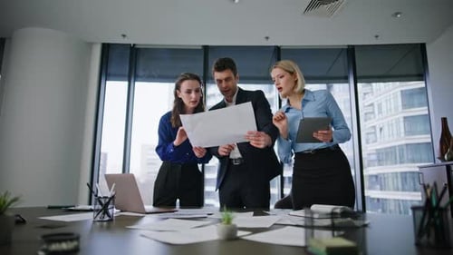 Business Team Analyzing Document in Modern Office