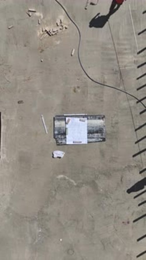 Vertical Video Waterproofing Layers Applied to Foundation Base As Metal Rods are Installed for