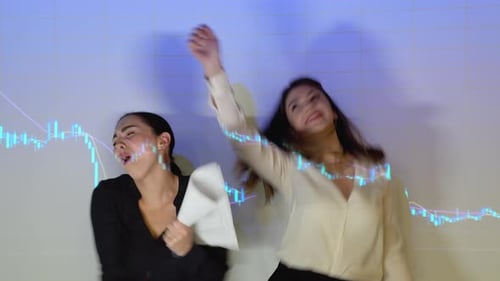 Two Funny Business Woman or Traders Dance Against the Background of Stock Market Chart
