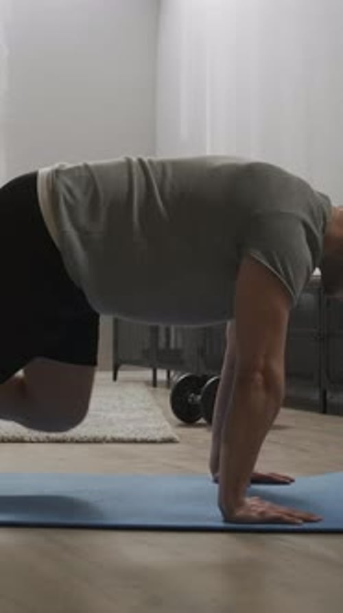 Man Doing Mountain Climber Exercise on Yoga Mat