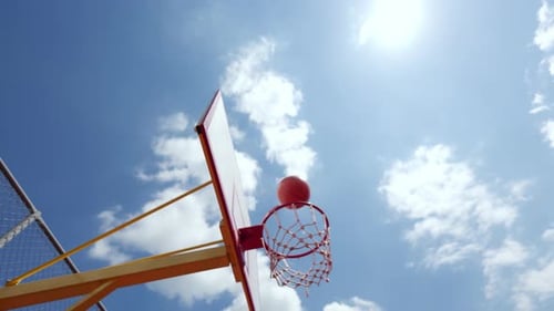 Young Caucasian Bearded Man Aiming Basketball Toward Hoop in Outdoor Game
