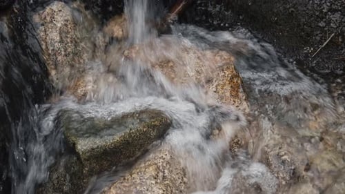 Mountain stream water flowing over rocks