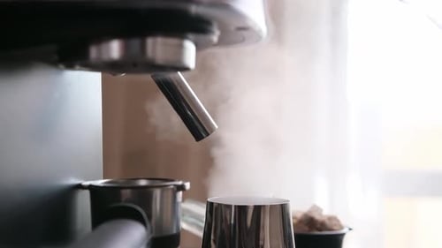 Espresso Machine Steaming Metallic Cup in Kitchen