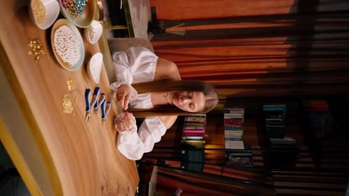 Young Woman Making Jewelry at Table Indoors
