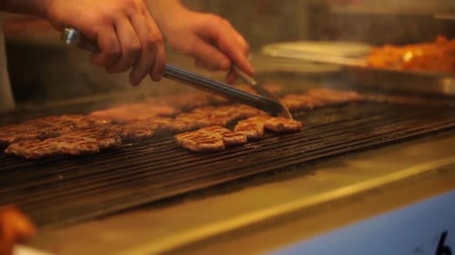 Meat Cutlets Cooking on a Grill