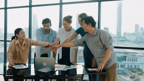 Diverse Team Celebrates Success in Modern Office Setting