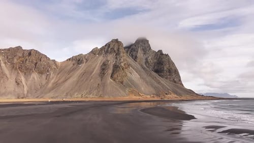 Aerial view of the dramatic Vestrahorn mountain range in Stokksnes, Iceland, with smooth black sand
