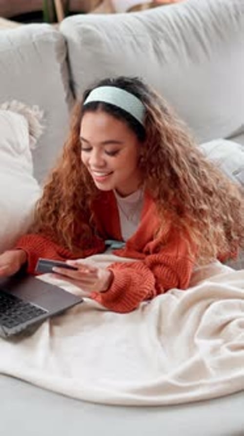 Smiling Woman Shopping Online with Laptop on Couch