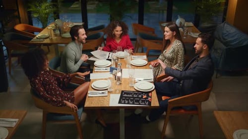 Multiethnic Friends Celebrating Have Fun In Night Fancy Restaurant. People Talking Together At Ev...