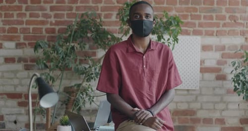 Portrait of African American Office Worker Wearing Face Mask Looking at Camera Indoors in Workplace