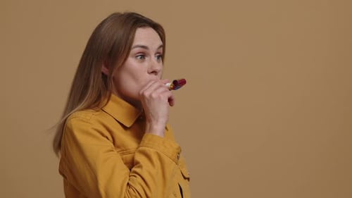 Enthusiastic Woman Blows Party Favor for Birthday