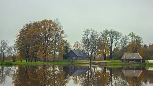 Houses along a lake during spring to summer, fall and winter in a time lapse