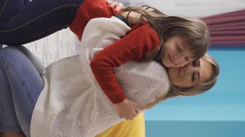 Loving Mother and Daughter Embrace in Home