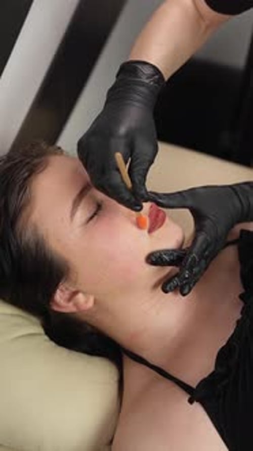 Esthetician Applies Facial Wax on Young Woman