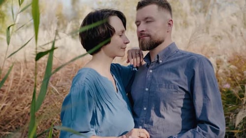 Couple in Love Embracing in Tall Grass