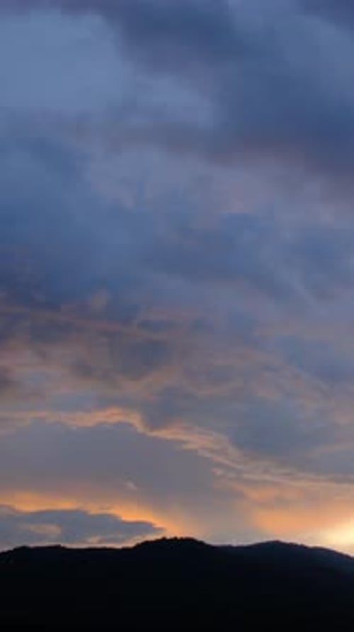 Dramatic Clouds over Mountains at Sunrise or Sunset
