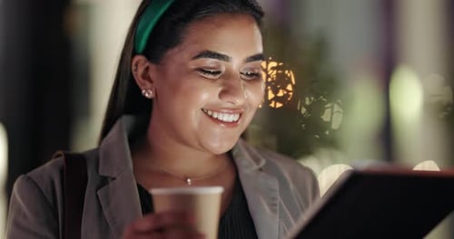 Smiling Woman Uses Tablet in City at Night