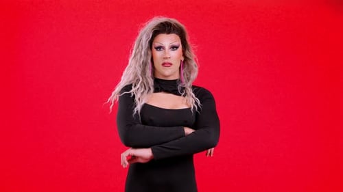 Glamorous Person with Curly Hair Posing Red Background