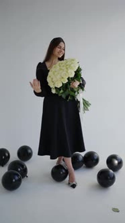 Woman Poses with Flowers and Balloons
