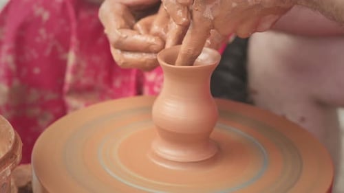 Hands Shaping Clay on a Pottery Wheel