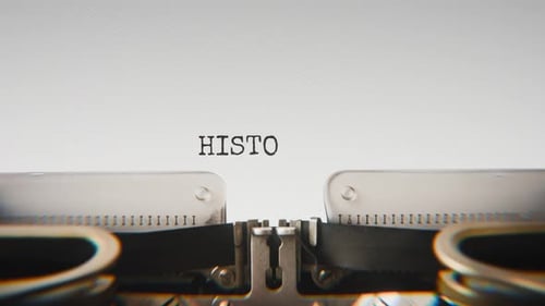 Old mechanical typewriter typing Historic Event in a close-up view.