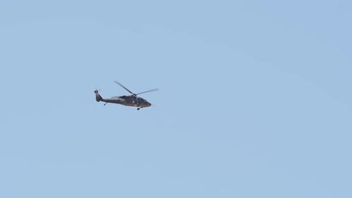 Helicopter Flying Across Blue Sky