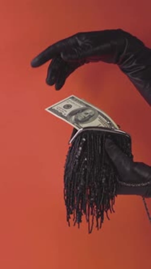 Cash Cascade Elegance with black leather gloves on red background
