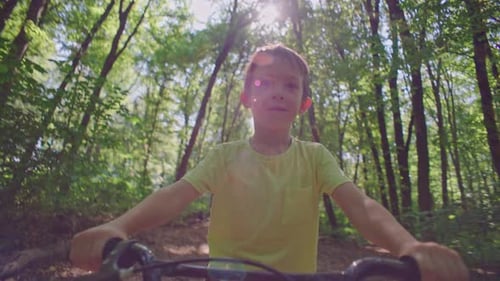 Closeup of Happy Smiling Child Riding Bicycle