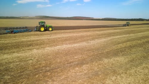 Tractors plowing the field in Ukraine