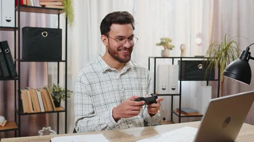 Man Playing Video Games at Desk