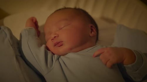 Sleeping Infant in Blue Pajamas Close Up