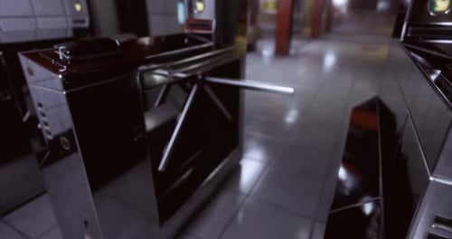 Modern Turnstiles in a Transit Station Corridor During Daylight
