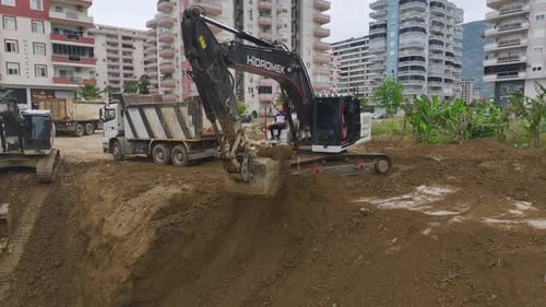 Aerial View Construction Kickoff Pouring Concrete and Heavy Machinery at Site