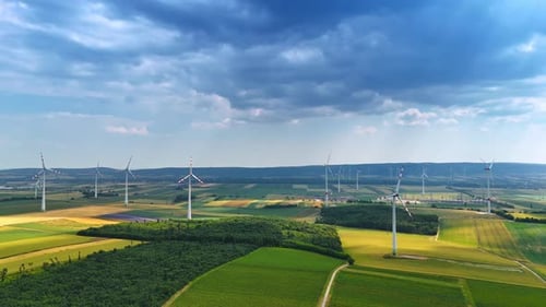 Wind Turbines Spin on Rural Farmland Aerial View