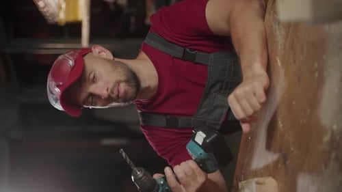 Construction Worker Drilling Wood with Power Drill