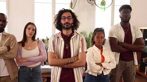 Startup team posing with confidence in modern office