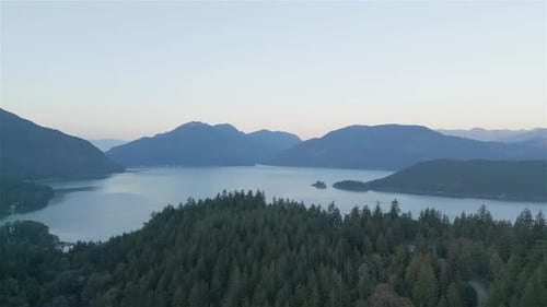 Aerial View of Lake and Green Trees in Forest Around Mountain Landscape