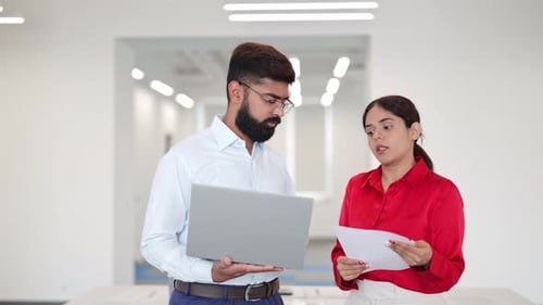 Business Professionals Discussing Data in Office