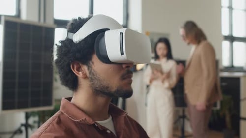 Man Exploring VR Technology in Bright Workplace