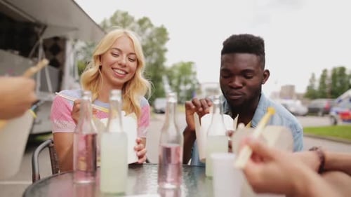 Friends Enjoying Food and Drinks at Food Truck