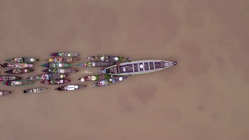 Aerial view of floating market with colorful boats, Indonesia.