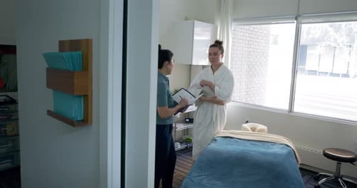 Woman consults with health professional in treatment room