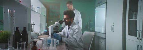 Scientists Working with Microscopes in a Modern Laboratory