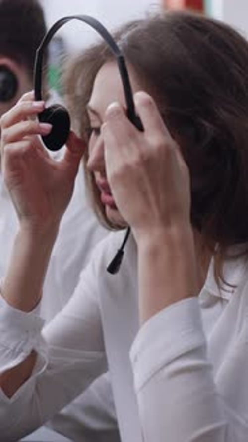 A Focused Female Call Center Agent is Efficiently Managing Tasks and Communication