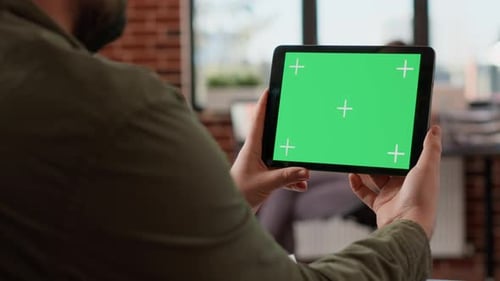Office Worker Holding Horizontal Greenscreen on Tablet