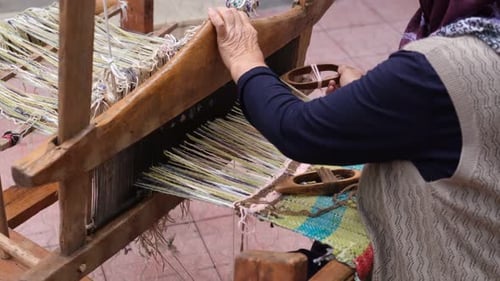 Peasant Woman Weaving A Rug In A Village House