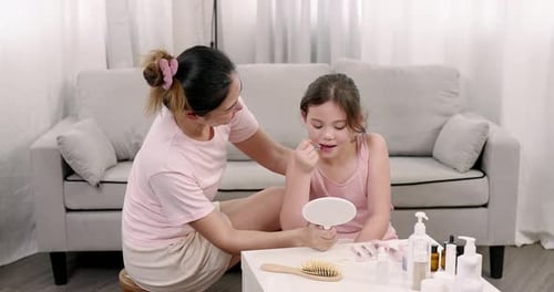 Mother and Child Doing Makeup Together in Home