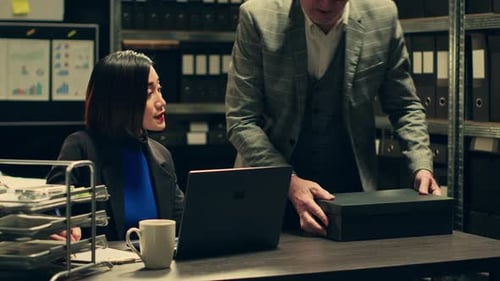 Coworkers Reviewing Documents in Office Storage Room
